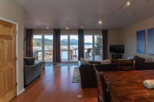 a living room with a couch and a table at Juneau Oceanfront Home Overlooking Auke Bay in Mendenhaven