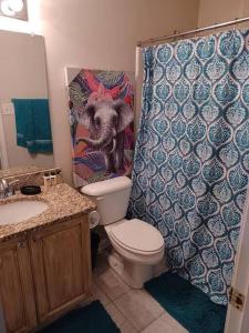 a bathroom with a dog in a shower curtain at Urban Adventure Townhome - Near Downtown Atlanta in Atlanta
