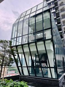 a glass office building with a large window at New 2BR or 3BR Homey Getaway at Urban Suites, Georgetown 7 to 10pax in Jelutong