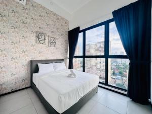 a bedroom with a bed and a large window at New 2BR or 3BR Homey Getaway at Urban Suites, Georgetown 7 to 10pax in Jelutong