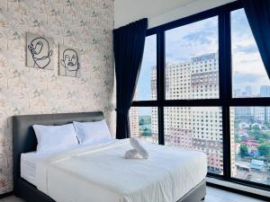 a bedroom with a bed with a large window at New 2BR or 3BR Homey Getaway stay 7 to 10 pax at Urban Suites, Georgetown by URBAN STAYCATION LOD in Jelutong +210 photos