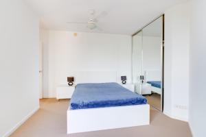 a bedroom with a bed and a mirror at Urban 2BR Gem: City Chic Retreat in Brisbane