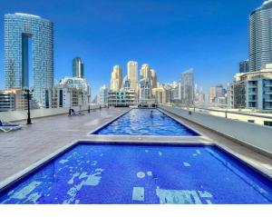 a large swimming pool on the roof of a building at Luxe Living: Dec Marina Haven_1br in Dubai Marina in Dubai