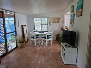 a living room with a white table and a tv at Pillar to Coast in Pillar Valley