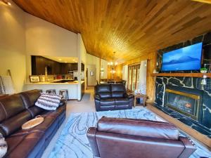 a living room with a couch and a fireplace at Ocean & Mountain View Duplex, both sides in Juneau