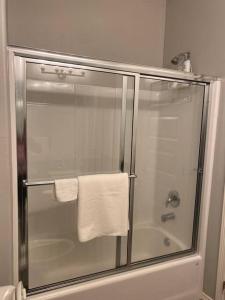 a shower with a glass door in a bathroom at Spacious Getaway near UTRGV in Edinburg