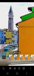 a view of a city with a clock tower in the background at Cà Comare Burano in Burano