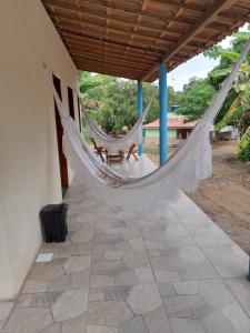 a porch with a hammock in a house at Chalé Primavera in Guaramiranga