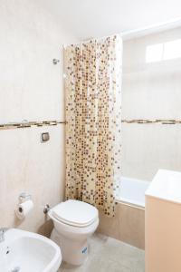 łazienka z toaletą i zasłoną prysznicową w obiekcie Alucinante studio! Centrico Moderno con balcon, apto 3 personas 71 w BuenosAires