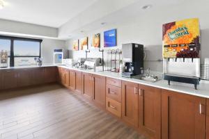 a large kitchen with wooden cabinets and a counter at Comfort Inn Dunn near I-95 in Dunn