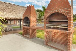 a brick pizza oven with a straw roof at Quality Inn Florida City - Gateway to the Keys in Florida City