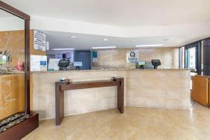 a lobby with a waiting area with a counter and chairs at Quality Inn Florida City - Gateway to the Keys in Florida City