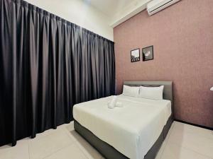 a bedroom with a large bed with black curtains at New 2BR or 3BR Homey Getaway at Urban Suites, Georgetown 7 to 10pax in Jelutong