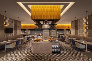 a rendering of a restaurant with tables and chairs at Courtyard by Marriott Tiruchirappalli in Tiruchirappalli