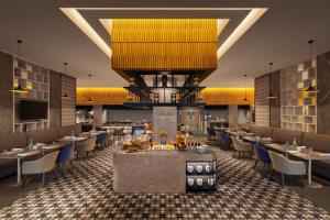 a rendering of a restaurant with tables and chairs at Courtyard by Marriott Tiruchirappalli in Tiruchchirāppalli