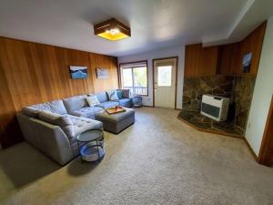 a living room with a couch and a tv at Breathtaking Ocean, Mountain & Juneau Views in Juneau