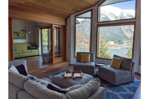 a living room with a couch and two chairs at Breathtaking Ocean, Mountain & Juneau Views in Juneau