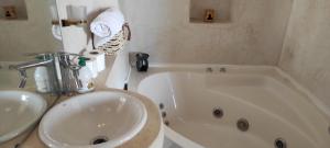 a bathroom with a white tub and a sink at SurfAppart Morocco in Tamraght Ouzdar