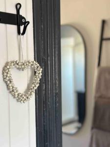 a heart hanging on a door with a mirror at Charming 3 bedroom wine country cottage in Rutherglen
