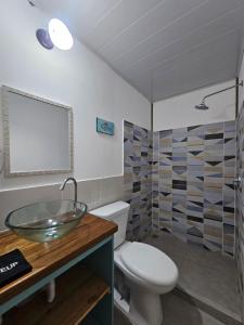 a bathroom with a sink and a toilet at Casa Pelicano in Bocas del Toro +39 photos