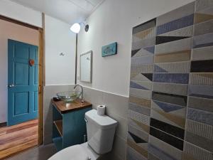 a bathroom with a toilet and a sink at Casa Pelicano in Bocas Town