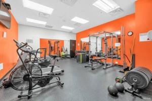 an orange gym with bikes and weights in a room at Modern Condo in the Heart of DT Overlooking City in Vancouver