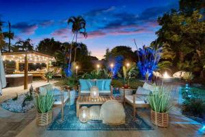 a patio with couches and a table with blue lights at Coastal Oasis Of Lantana in Lantana