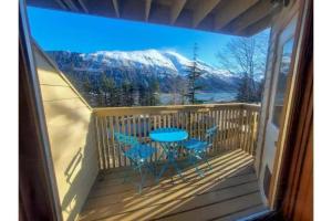 a patio with a table and chairs on a balcony at Lovely Condo Across from Downtown w/ Mountain View in Juneau