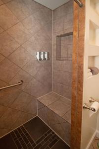 a shower with a glass door and a shower at Quiet, gated oasis near downtown Lexington in Lexington