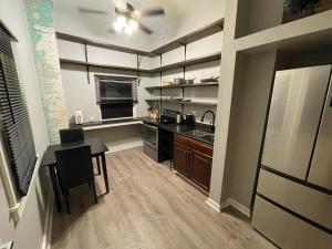 a small kitchen with a table and a stove at Quiet, gated oasis near downtown Lexington in Lexington