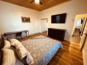 a bedroom with a bed and a flat screen tv at Quiet, gated oasis near downtown Lexington in Lexington