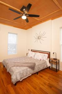 a bedroom with a bed with a ceiling fan at Quiet, gated oasis near downtown Lexington in Lexington