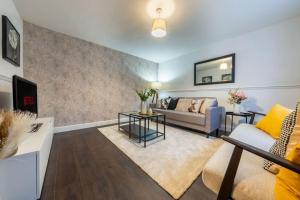 a living room with a couch and a table at Modern Wolverhampton 3 bed Home in Wolverhampton