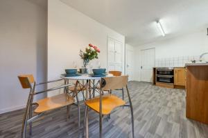 a kitchen with a table and chairs in a room at Modern Wolverhampton 3 bed Home in Wolverhampton