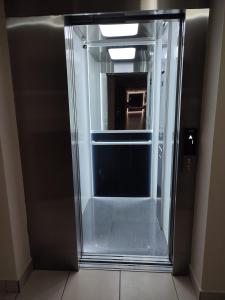 an empty glass elevator in a building at JR HOTEL in Refineria Camiri