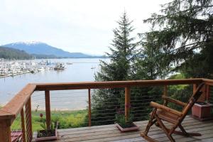 a wooden deck with a bench and a view of a harbor at Family Getaway in Juneau Unforgettable Ocean Views in Mendenhaven
