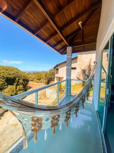 a hammock on the balcony of a house at Morada da Lagoinha in Florianópolis