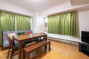 a living room with a table and a couch at Angel Resort Yuzawa in Yuzawa