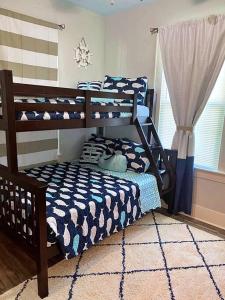 a bedroom with two bunk beds in a room at The Poolside Bungalow in Galveston