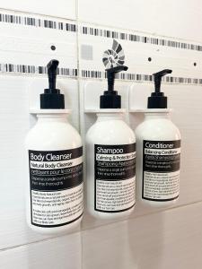 three bottles of body cleaner sitting on a shelf at SeoulStory Hanok in Seoul