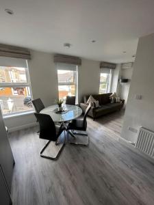 a living room with a table and chairs and a couch at Westland Suites - Stylish, Modern, Elegant, Central Apartments in Londonderry County Borough