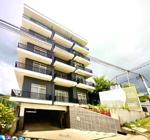 a tall building with balconies on the side of it at THE WIND LILY - Lake View Luxury Apartment in Nuwara Eliya