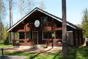 a large wooden house in the woods at Ferienhaus in Kouvola mit Terrasse und Grill in Kouvola