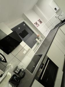 a person is standing in a kitchen with a stove at New York by D&J Apartments Altenessen Nord in Essen