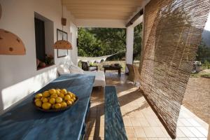 a bowl of fruit on a table on a patio at Hacienda Ses Caletes in Cala San Vicente