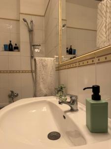 a bathroom sink with a faucet and a mirror at Extralarge Queen Room in the Heart of Bratislava with Terrace in Bratislava