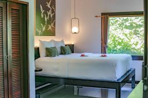 Postel nebo postele na pokoji v ubytování Uluwatu Yoga Resort