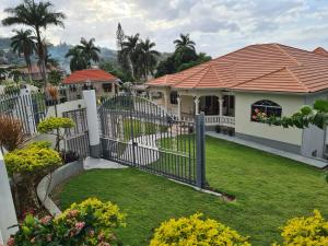 a gate in the yard of a house at La Rose Apartment in Montego Bay