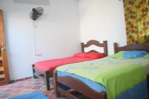 1 Schlafzimmer mit 2 Betten und einem Ventilator in der Unterkunft Shaddai restaurante y hospedaje in Puerto Triunfo