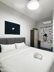 a white bed with two towels on top of it at Room with PrivateBathroom, Projector, KSL Mall in Johor Bahru